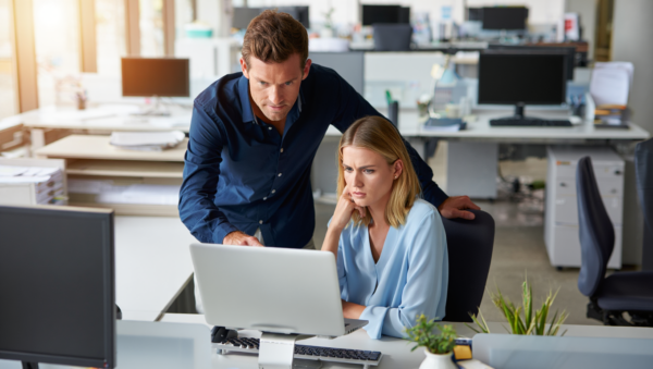 DKs Managed IT specialists collaborating on technical solutions and server management in a modern office.